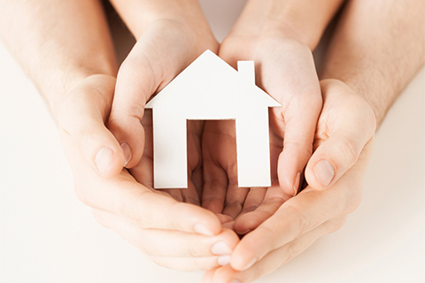 Woman and hands with paper house